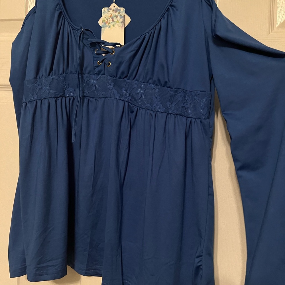 Women’s blouse. NWT. Cut out shoulders. Lace at the empire waist.